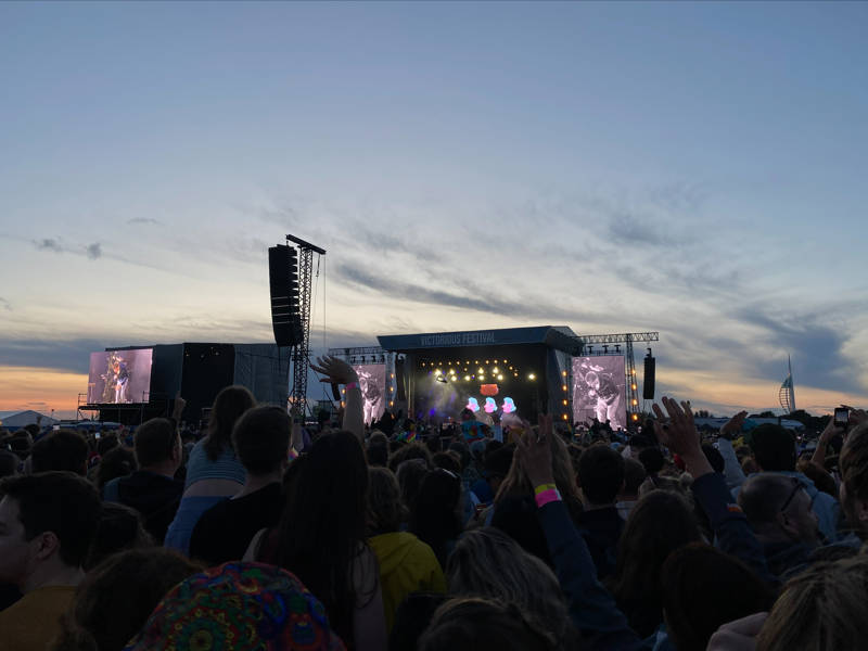 Looking over the crowd to the main stage at dusk during the Victorious Festival