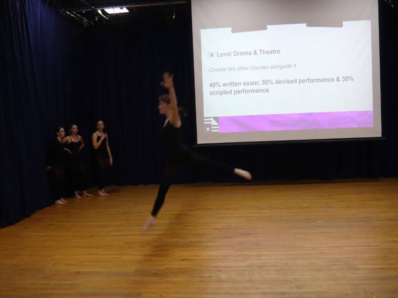 Performing Arts student mid air during performance in theatre.
