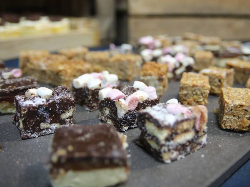 Close up of rocky road and flapjack cakes on table