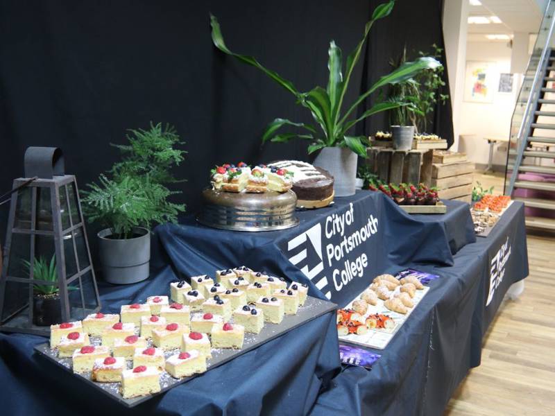 COPC branded cake display in refectory at Open Event.