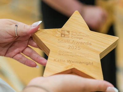 A star shaped wooden trophy for the staff awards at City of Portsmouth College 