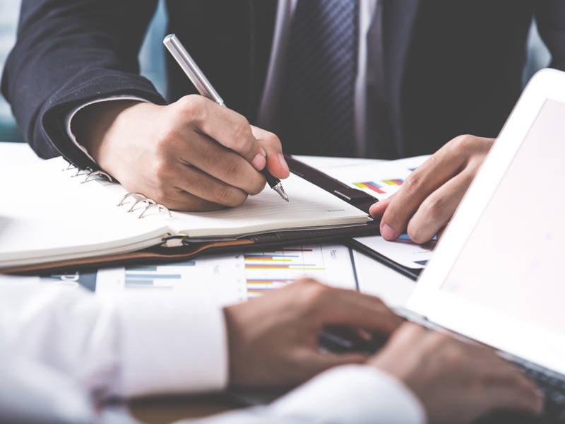 Business adviser analysing financial figures denoting the progress in the work of the company