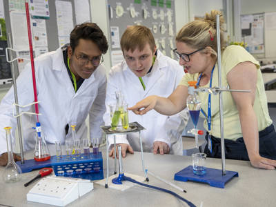 Two students and a lecturer undertaking a science experiment at City of Portsmouth College 