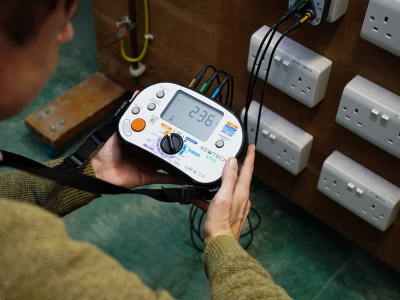 Electrical student using specialist equipment in Electrical workshop.