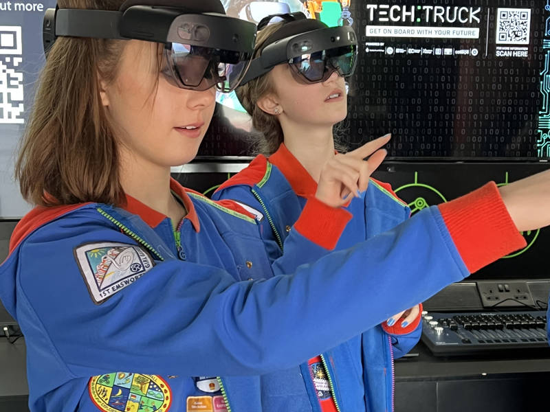 Two girl guides using augmented reality headsets.