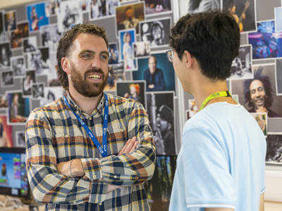 A music lecturer chatting with a student at City of Portsmouth College 