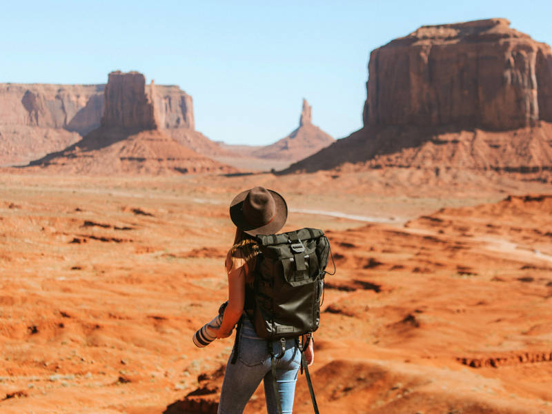 Adventurous young women hiking through a desert.